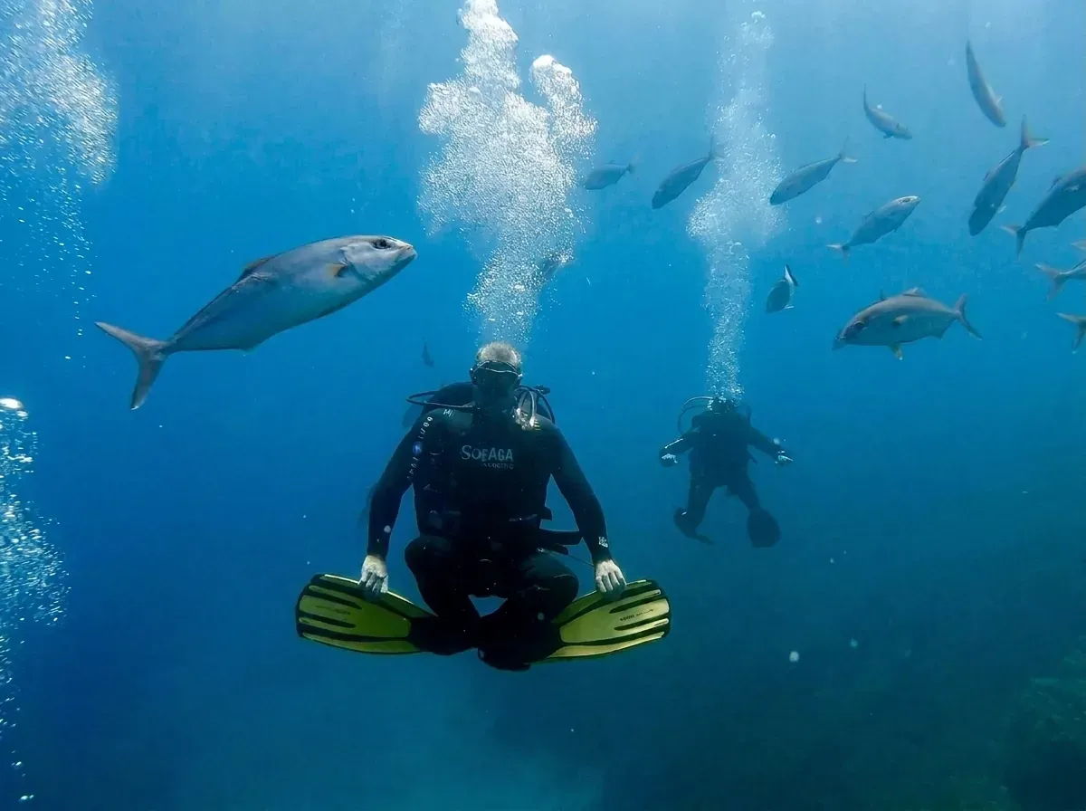 Scuba divers exploring the crystal clear waters of Halkidiki